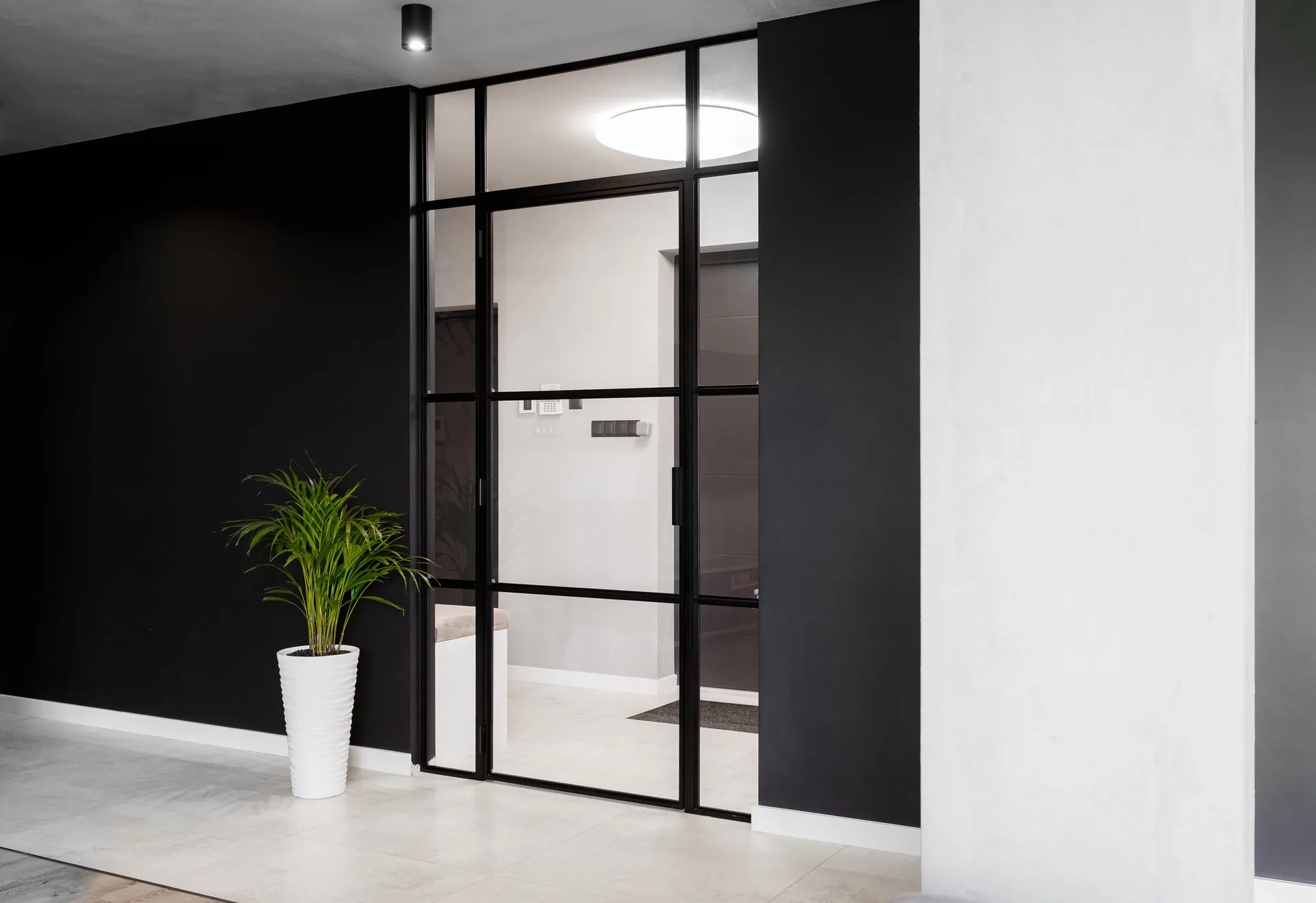 Black slim aluminium glazed partition in a modern interior